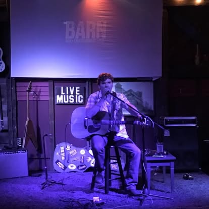 Justin by the rustic barn